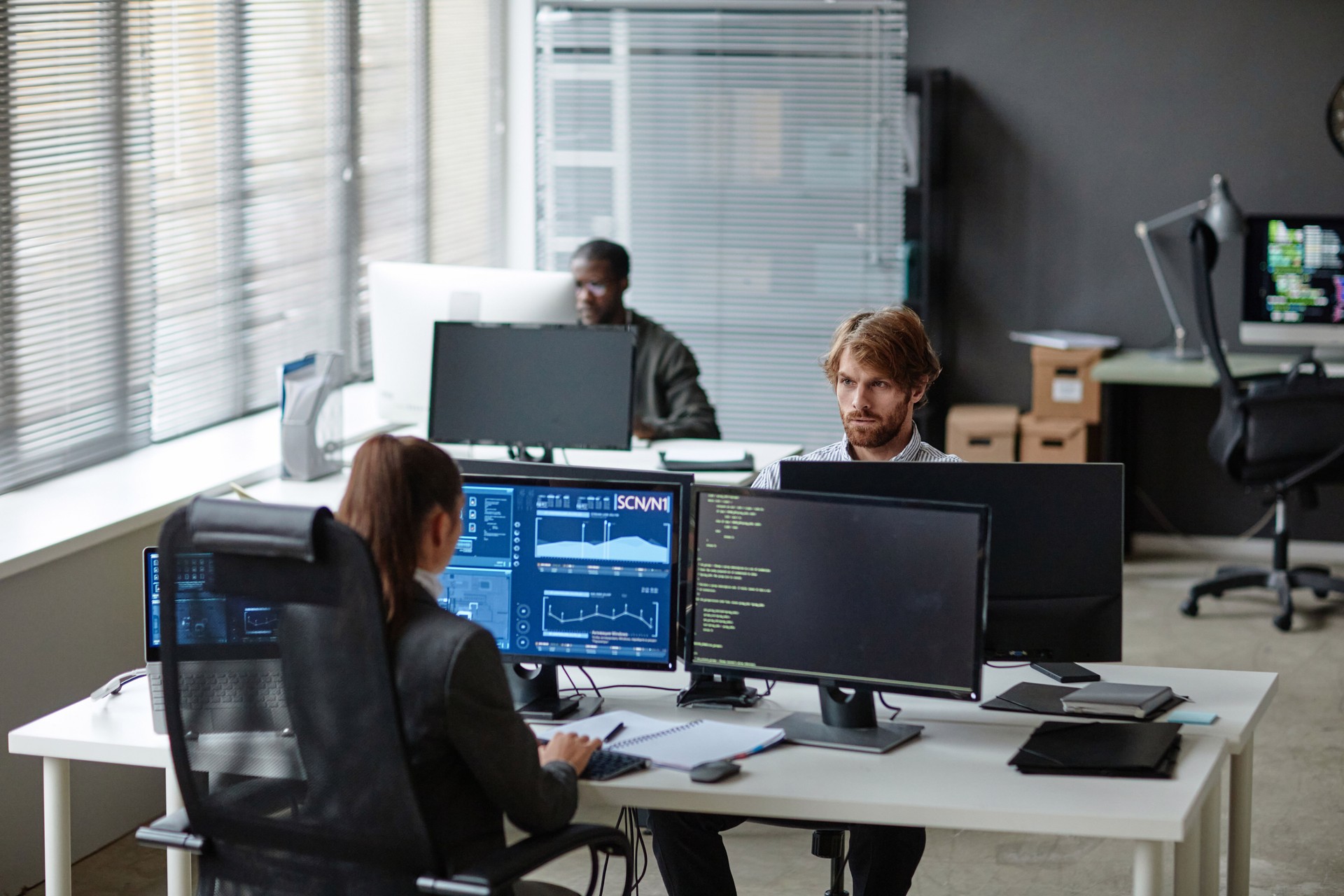 Young IT Developers Working with Multiple Computers